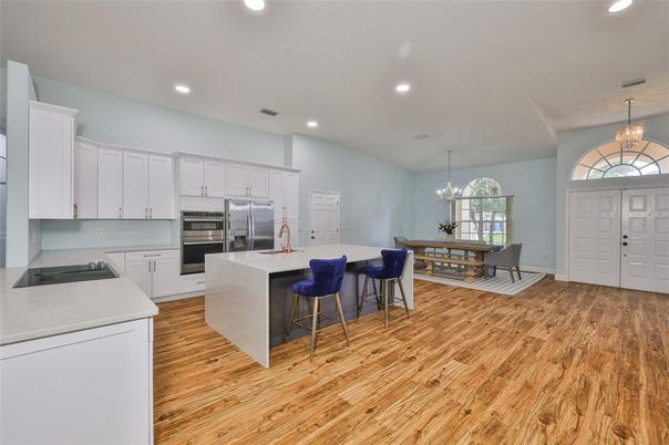 Chandelier, Dining room, Interior, Kitchen, Recessed Lighting, Stainless Steel Appliances, Wood Texture Flooring