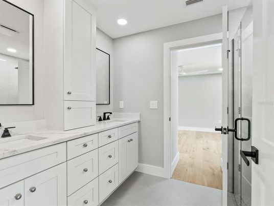 Bathroom, Dual Sink Vanities, Glass Shower, Interior, Recessed Lighting, Wood Texture Flooring