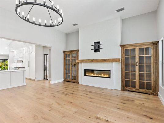 Chandelier, Empty room, Fireplace, Interior, Kitchen, Recessed Lighting, Wood Texture Flooring