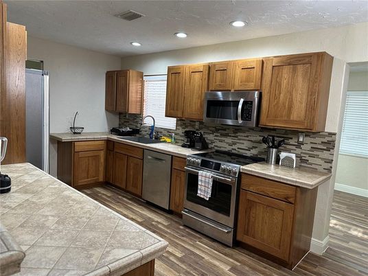 Interior, Kitchen, Recessed Lighting, Stainless Steel Appliances, Tile Countertops, Wood Texture Flooring