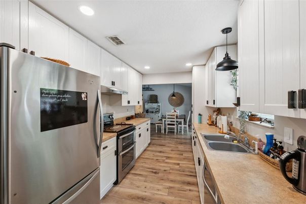 Dining room, Interior, Kitchen, Pendant Lights, Recessed Lighting, Stainless Steel Appliances, Wood Texture Flooring