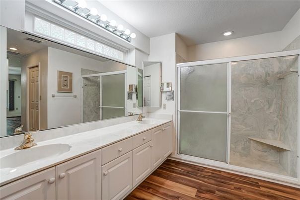 Bathroom, Dual Sink Vanities, Glass Shower, Interior, Recessed Lighting, Wood Texture Flooring