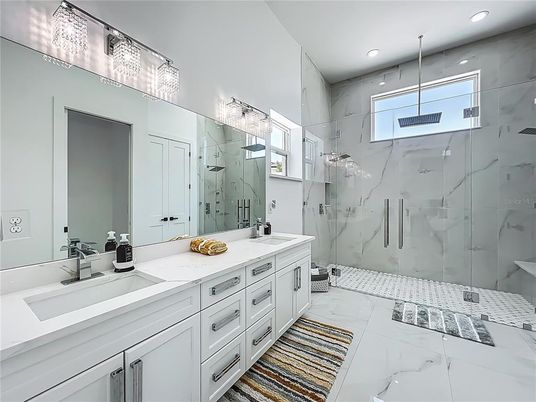 Bathroom, Dual Sink Vanities, Glass Shower, Interior, Marble, Marble Walls, Recessed Lighting
