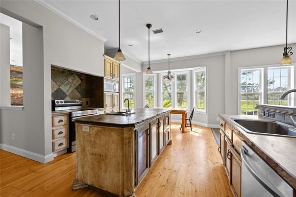 Dining room, Interior, Kitchen, Pendant Lights, Recessed Lighting, Stainless Steel Appliances, Wood Texture Flooring