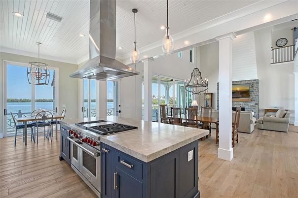 Dining room, Fireplace, Interior, Kitchen, Living room, Pendant Lights, Recessed Lighting, Stainless Steel Appliances, Water, Wood Texture Flooring