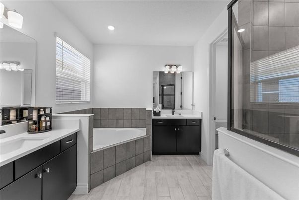 Bathroom, Dual Sink Vanities, Glass Shower, Interior, Recessed Lighting, Wood Texture Flooring