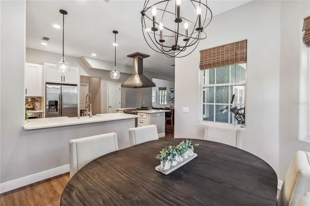 Chandelier, Dining room, Interior, Kitchen, Pendant Lights, Recessed Lighting, Stainless Steel Appliances, Wood Texture Flooring