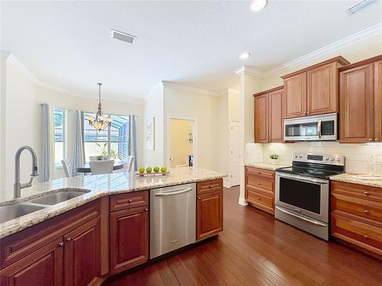 Chandelier, Dining room, Interior, Kitchen, Pendant Lights, Recessed Lighting, Stainless Steel Appliances, Wood Texture Flooring