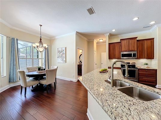 Chandelier, Dining room, Interior, Kitchen, Recessed Lighting, Stainless Steel Appliances, Wood Texture Flooring