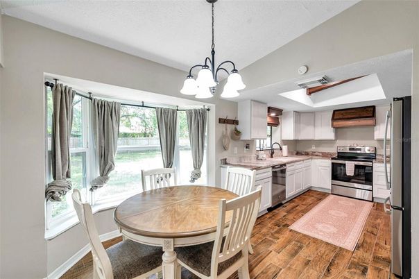 Chandelier, Dining room, Interior, Kitchen, Pendant Lights, Stainless Steel Appliances, Wood Texture Flooring