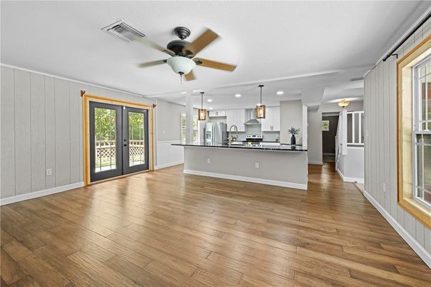 Empty room, Interior, Kitchen, Pendant Lights, Recessed Lighting, Stainless Steel Appliances, Wood Texture Flooring