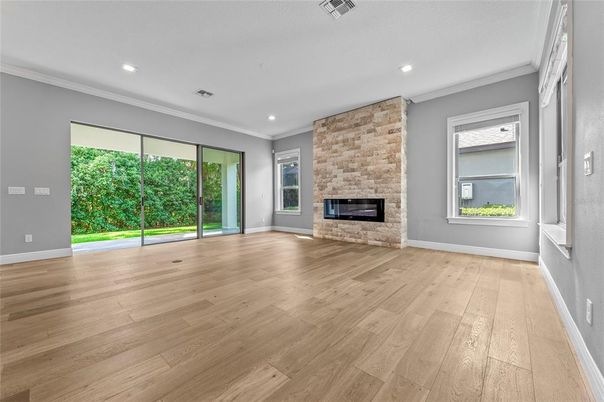 Empty room, Fireplace, Interior, Recessed Lighting, Stone Walls, Wood Texture Flooring