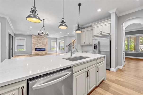 Fireplace, Interior, Kitchen, Pendant Lights, Recessed Lighting, Stainless Steel Appliances, Stone Walls, Wood Texture Flooring