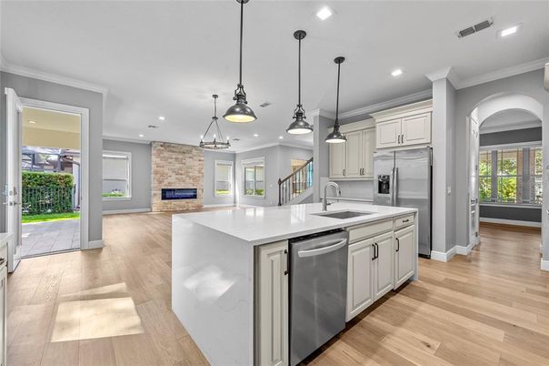 Fireplace, Interior, Kitchen, Pendant Lights, Recessed Lighting, Stainless Steel Appliances, Stone Walls, Wood Texture Flooring
