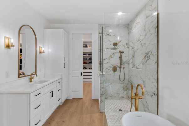 Bathroom, Dual Sink Vanities, Glass Shower, Interior, Marble Walls, Recessed Lighting, Walk-in Closets, Wood Texture Flooring