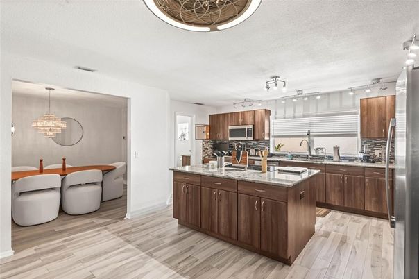 Chandelier, Interior, Kitchen, Pendant Lights, Stainless Steel Appliances, Tile Countertops, Wood Texture Flooring