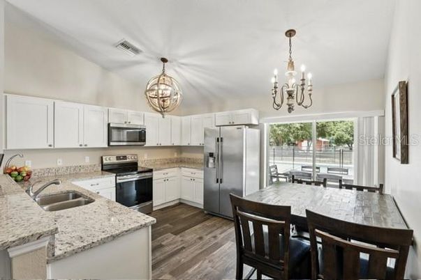 Chandelier, Dining room, Interior, Kitchen, Stainless Steel Appliances, Wood Texture Flooring
