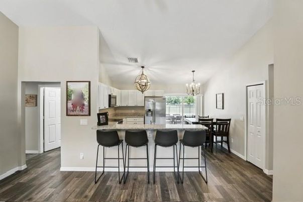 Chandelier, Dining room, Interior, Kitchen, Stainless Steel Appliances, Wood Texture Flooring