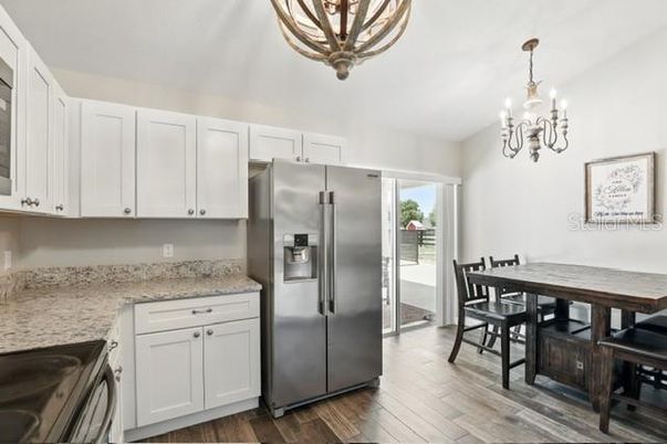 Chandelier, Dining room, Interior, Kitchen, Stainless Steel Appliances, Wood Texture Flooring