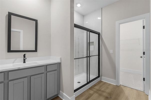 Bathroom, Dual Sink Vanities, Glass Shower, Interior, Recessed Lighting, Wood Texture Flooring