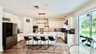 Chandelier, Interior, Kitchen, Pendant Lights, Recessed Lighting, Stainless Steel Appliances, Wood Texture Flooring