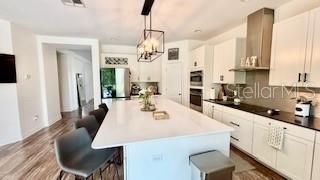 Chandelier, Dining room, Interior, Kitchen, Pendant Lights, Recessed Lighting, Stainless Steel Appliances, Wood Texture Flooring