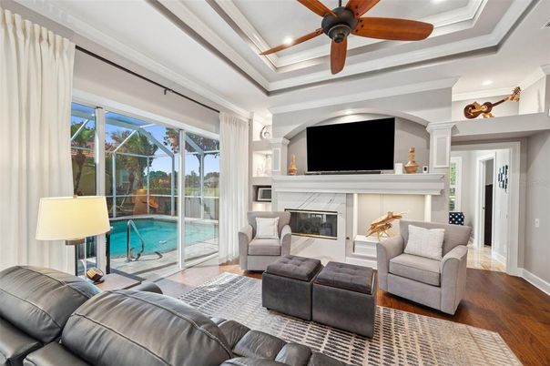 Fireplace, Interior, Living room, Pool, Recessed Lighting, Sun Room, Wood Texture Flooring