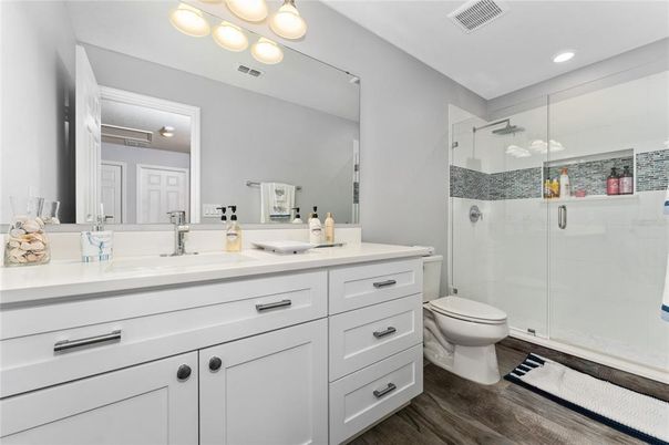 Bathroom, Dual Sink Vanities, Glass Shower, Interior, Recessed Lighting, Wood Texture Flooring