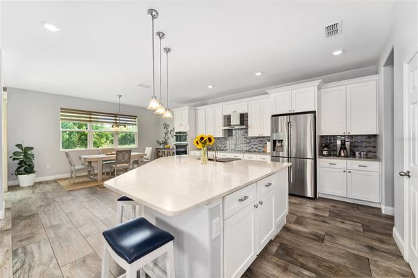 Dining room, Interior, Kitchen, Pendant Lights, Recessed Lighting, Stainless Steel Appliances, Wood Texture Flooring