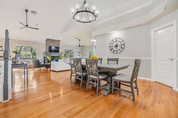 Chandelier, Dining room, Fireplace, Interior, Living room, Pendant Lights, Recessed Lighting, Wood Texture Flooring