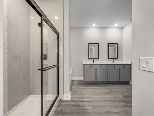 Bathroom, Dual Sink Vanities, Glass Shower, Interior, Recessed Lighting, Wood Texture Flooring
