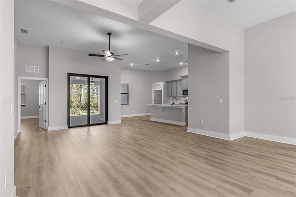 Empty room, Interior, Kitchen, Recessed Lighting, Stainless Steel Appliances, Wood Texture Flooring