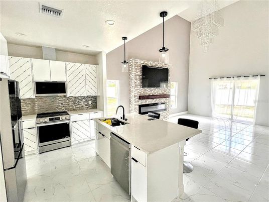 Fireplace, Interior, Kitchen, Marble, Pendant Lights, Recessed Lighting, Stainless Steel Appliances