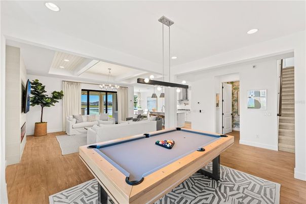 Billiard Table, Chandelier, Game Room, Interior, Living room, Pendant Lights, Recessed Lighting, Wood Texture Flooring