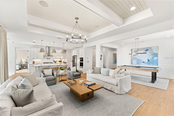 Billiard Table, Chandelier, Game Room, Interior, Kitchen, Living room, Pendant Lights, Recessed Lighting, Stainless Steel Appliances, Wood Texture Flooring