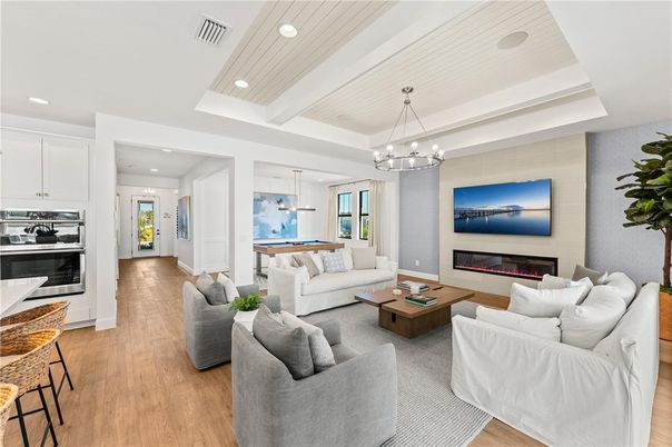 Billiard Table, Chandelier, Fireplace, Game Room, Interior, Living room, Pendant Lights, Recessed Lighting, Wood Texture Flooring