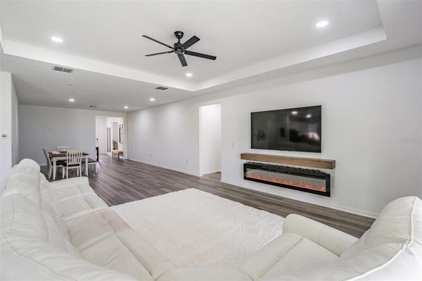 Dining room, Fireplace, Interior, Living room, Recessed Lighting, Wood Texture Flooring