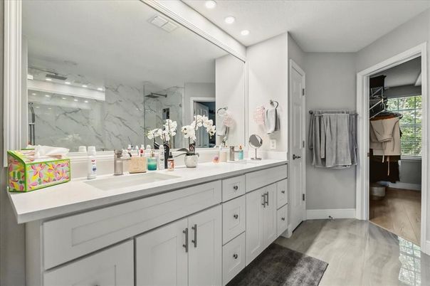 Bathroom, Dual Sink Vanities, Interior, Marble Walls, Recessed Lighting, Walk-in Closets, Wood Texture Flooring