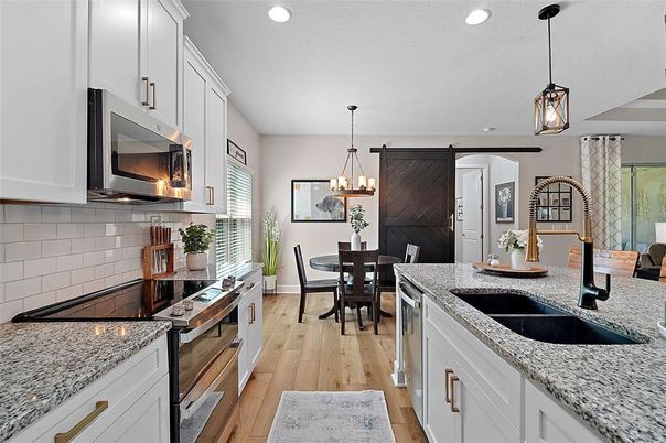Chandelier, Dining room, Interior, Kitchen, Pendant Lights, Recessed Lighting, Stainless Steel Appliances, Wood Texture Flooring