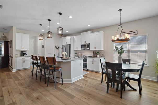 Chandelier, Dining room, Interior, Kitchen, Pendant Lights, Recessed Lighting, Stainless Steel Appliances, Wood Texture Flooring