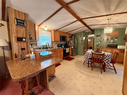 Chandelier, Dining room, Interior, Kitchen, Pendant Lights, Stainless Steel Appliances, Wooden Beams