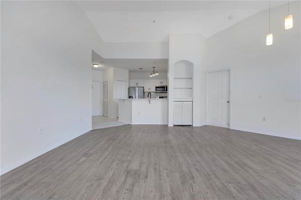 Empty room, Interior, Kitchen, Pendant Lights, Stainless Steel Appliances, Wood Texture Flooring