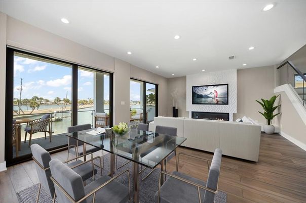 Dining room, Fireplace, Interior, Living room, Recessed Lighting, Water, Wood Texture Flooring
