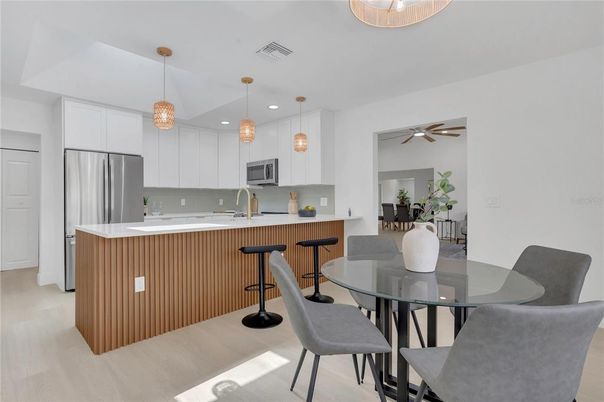 Dining room, Interior, Kitchen, Pendant Lights, Recessed Lighting, Stainless Steel Appliances, Wood Texture Flooring