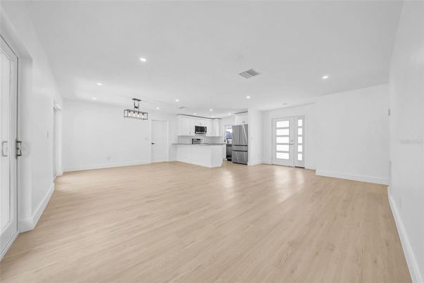 Empty room, Interior, Kitchen, Pendant Lights, Recessed Lighting, Stainless Steel Appliances, Wood Texture Flooring