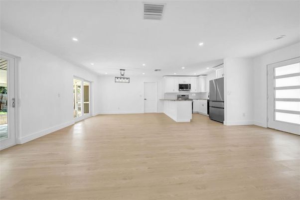 Empty room, Interior, Kitchen, Pendant Lights, Recessed Lighting, Stainless Steel Appliances, Wood Texture Flooring