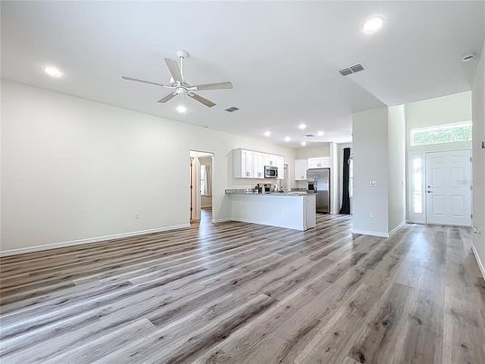 Empty room, Interior, Kitchen, Recessed Lighting, Stainless Steel Appliances, Wood Texture Flooring