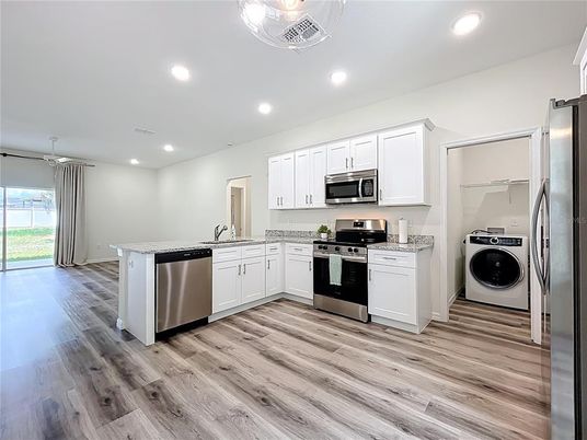 Interior, Kitchen, Recessed Lighting, Stainless Steel Appliances, Washer, Wood Texture Flooring