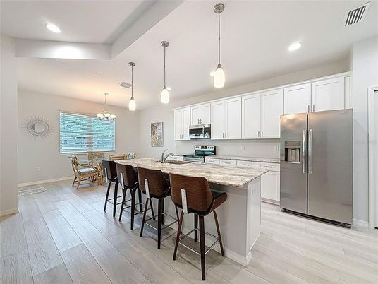 Chandelier, Dining room, Interior, Kitchen, Pendant Lights, Recessed Lighting, Stainless Steel Appliances, Wood Texture Flooring