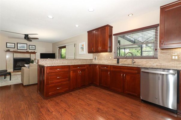 Fireplace, Interior, Kitchen, Recessed Lighting, Stainless Steel Appliances, Wood Texture Flooring